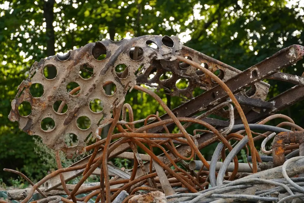 A heap of rusted rebar, steel pipe and cable ready for scrap metal recycling